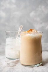 Coffee with ice cream and cinnamon in glass cup. Selective focus.