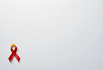 Red and yellow awareness ribbon on a plain white background : World Hepatitis Day. A close-up image of a red and yellow awareness ribbon against a plain white background.