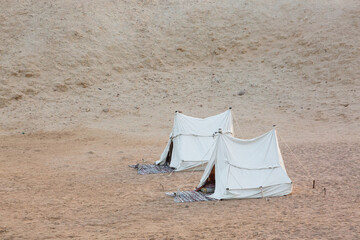 Two Traditional Bedouin tents in the desert at sunset near Sinai mountains. Night sleep excursion...
