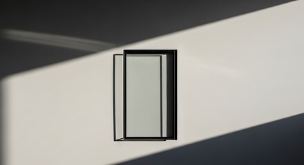 Minimalist Black Frame on White Wall Bathed in Sunlight creating Abstract Shadows