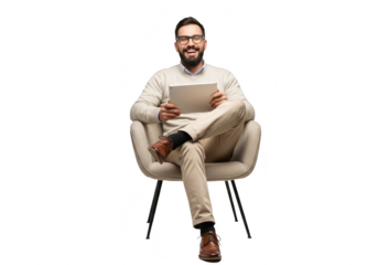 A smiling man with a beard and glasses sits comfortably in a modern chair holding and looking at a tablet device isolated on transparent background