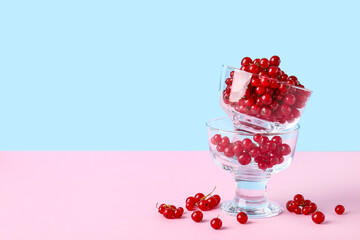 Dessert bowls with fresh red currants on color background, closeup
