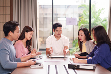 Fototapeta premium Asian business professionals team discussion strategy collaboration meeting modern office planning exchanging ideas