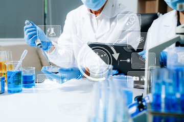 Scientists in a high tech lab conduct research with pipettes and tablets, blending medical...