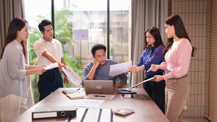 Asian business professionals intense meeting discussing reports team collaboration project pressure...