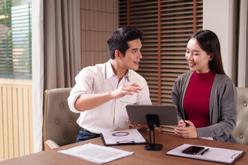 Asian business professionals discuss project data using tablet presentation modern office meeting room strategy collaboration