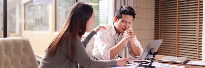 Asian business professionals adults collaborate support analyze data discuss project solutions modern office environment strategic planning