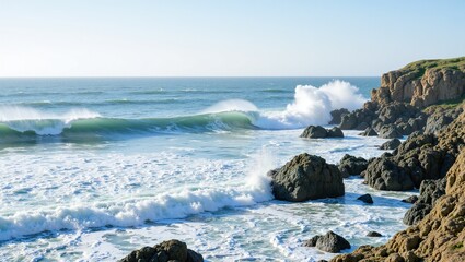 Ocean waves crash powerfully against jagged rocks along a sunlit coastline, sending sprays of foam into the warm sea breeze