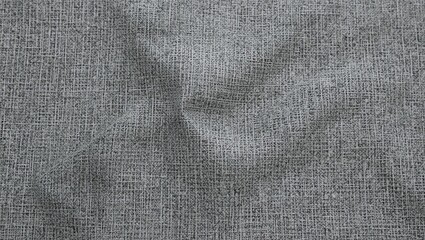 Close-up texture of gray fabric showcasing unique patterns and folds for design or textile inspiration.