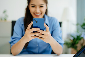 Business woman using smartphone and working on laptop computer  Woman freelancer online working at office
