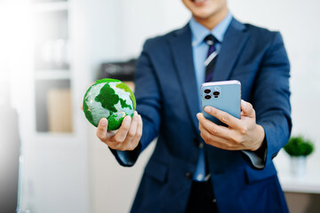 Businessman in suit holding a green earth model, symbolizing global sustainability, eco leadership, and modern corporate responsibility