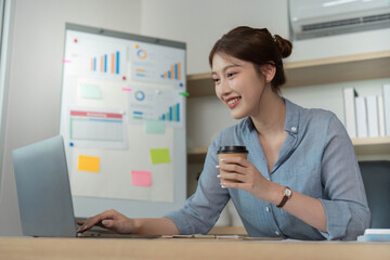 Remote Work. Smiling woman using laptop for business tasks.