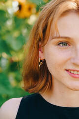 Half Face Portrait of Smiling Redhead Woman Outdoors