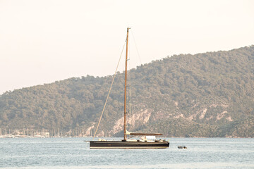 Sailboat anchored in the Gulf of Marmaris. Watercraft idea concept. Sailboat on a peaceful summer day. Sea view. 