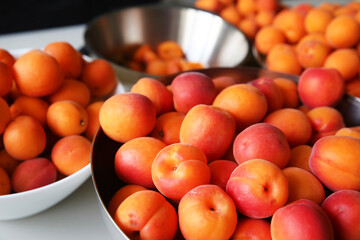 ripe, juicy apricots in bowls, preparation of apricots for jam