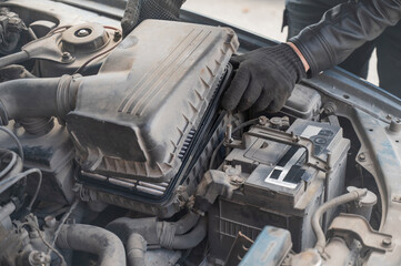 Mechanic changing the air filter. 
