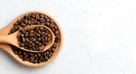 Two wooden spoons filled with roasted coffee beans
