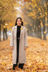 Portrait of a young beautiful long-haired girl in autumn outdoors.