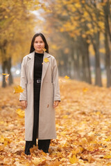 Portrait of a young beautiful long-haired girl in autumn outdoors.