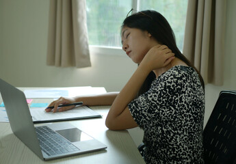 Businesswoman is massaging her shoulder with her hands. Shoulder pain from work fatigue and muscle...