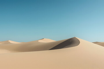 Clean, minimalistic shot of smooth sand dunes under a clear blue sky
