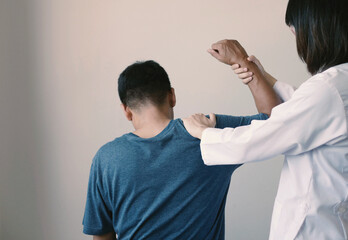 A male Asian patient received physical therapy for chronic, severe pain with a physical therapist...