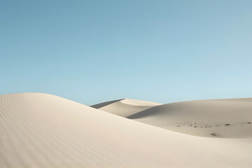 Clean, minimalistic shot of smooth sand dunes under a clear blue sky