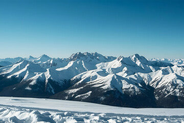 Panoramic view of a majestic snow-covered mountain range under a crisp blue sky