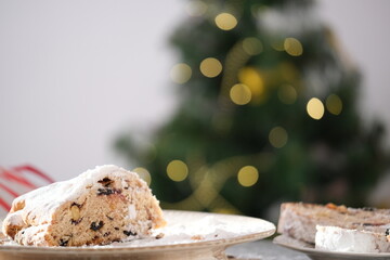 A delicious looking baked treat presented on a wooden board, showcasing various nuts and dried fruits. Christmas stollen. Traditional German sweet bread.