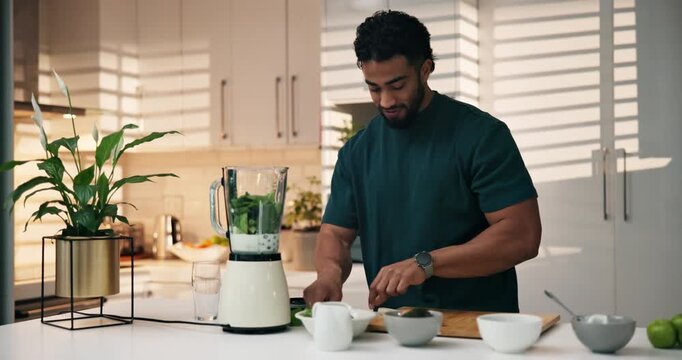 Man, leaves and ingredients with blender in kitchen, happy and meal prep for liquid diet at home. Person, mint and milkshake for wellness, nutrition or detox for gut health benefits at apartment