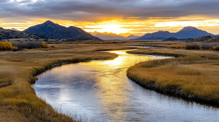 Golden hour river bend reflects mountains in distance, creating serene landscape