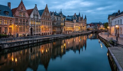 Canal scene at dawn, European city.  Colorful, historic buildings reflect in still water