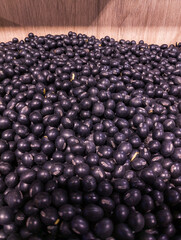 Organic Black Soybeans in Wooden Farm Bin, High-Protein Legume (Top Angle)