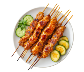 Delicious grilled chicken satay skewers served on a white plate with fresh cucumber garnish transparent background