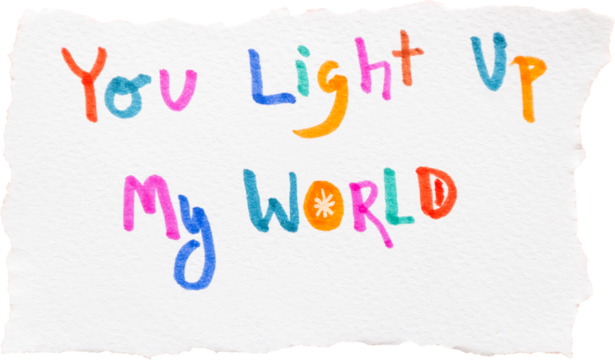 Colorful "You light up my world" handwritten text on textured paper for inspirational quotes or greeting cards