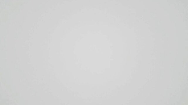 A uniform solid expanse in a muted gray hue devoid of any discernible features or textures