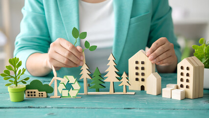 Eco-conscious businesswoman showcasing sustainable living concepts with wooden houses and trees