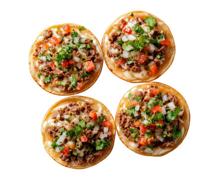Delicious mini tostadas with ground beef topped with fresh vegetables and herbs isolated on transparent background