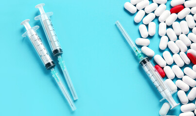Heap of pills on blue background