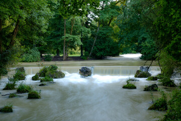 Small, artificial waterfall in the Eisbach, English Garden, Munich, Bavaria, Germany in summer