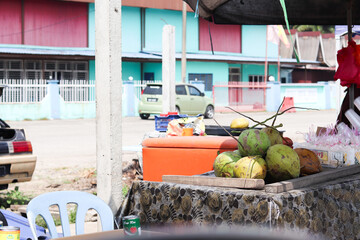 Old Street Vendor Selling Fresh Coconuts