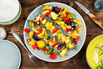 Delicious grilled fish and vegetables on wooden surface.