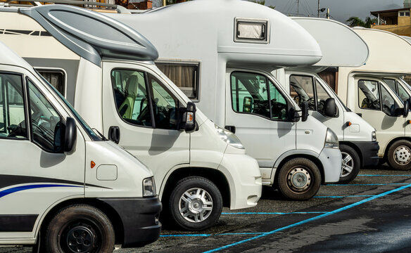 campers and motorhomes on asphatl parning, white auto caravan for  vacation travel