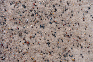 Colorful Pebbles Scattered On Sandy Beach Surface