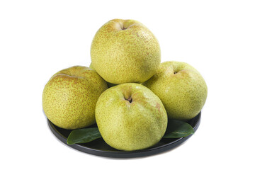 Display of Dangshan Crisp Pears on a black plate with fresh leaves against a white background