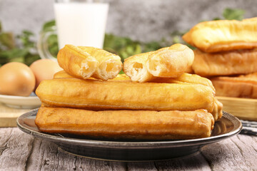 Crispy traditional fritters with a golden brown exterior served on a plate beside fresh ingredients