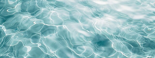 Obraz premium A mesmerizing close-up captures the undulating surface of turquoise water, reflecting light and creating a dynamic, rippling pattern.