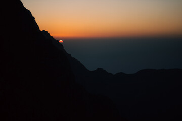 Cinematic stock photo of sunset on the mountain peak with mountain range silhouette, Limited edition landscape print 