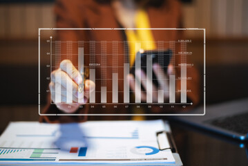 Closeup of smartphone user planning with a futuristic dashboard UI, featuring data visualization,...