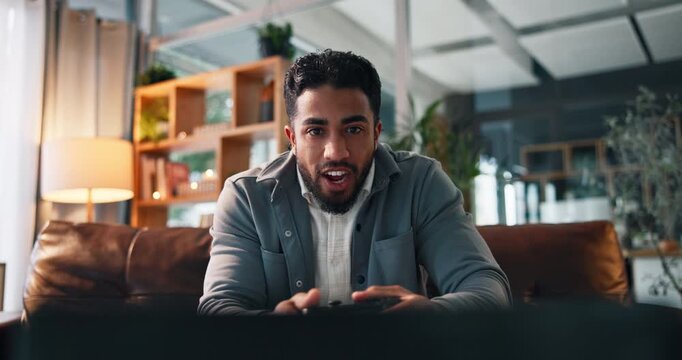 Man, video game and controller on couch for fist pump, challenge and esports goals in living room. Person, gamer and winner on sofa with console, television and celebration for next level at home